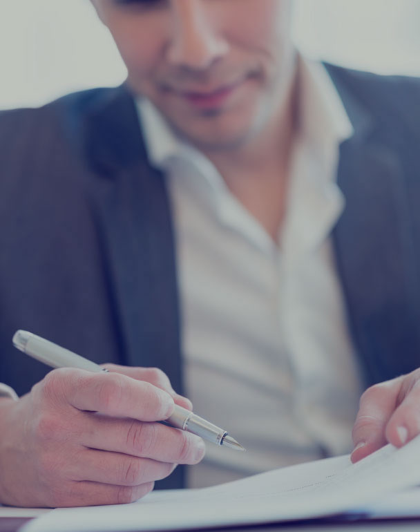 Man in a suit signing his will